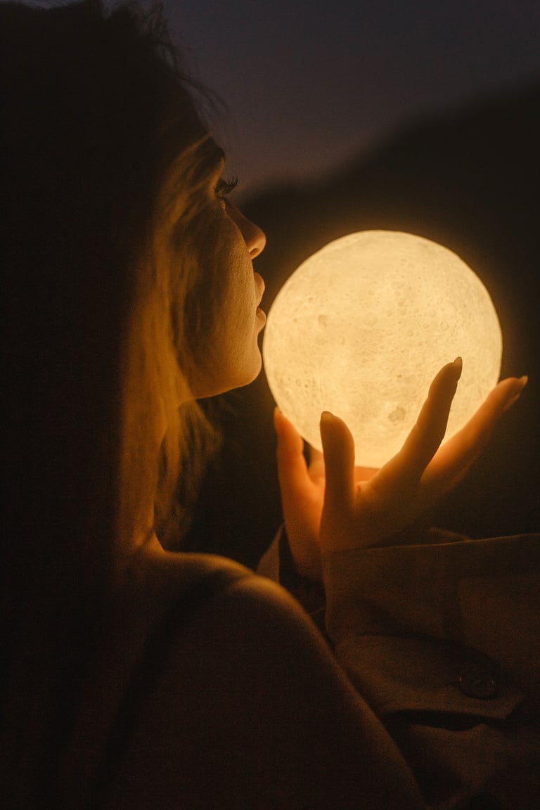 Woman Holding Moon during Night Time